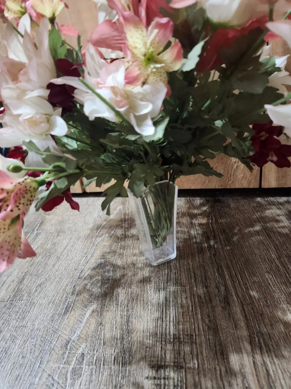 vintage floral arrangement of artificial flowers in small vase